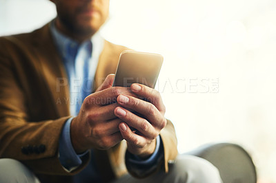 Buy stock photo Cropped shot of an unrecognizable businessman using a mobile phone