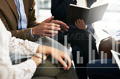 Buy stock photo Cropped shot of a group of unrecognizable businesspeople sitting in a meeting