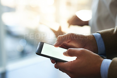 Buy stock photo Cropped shot of a businessman using his cellphone