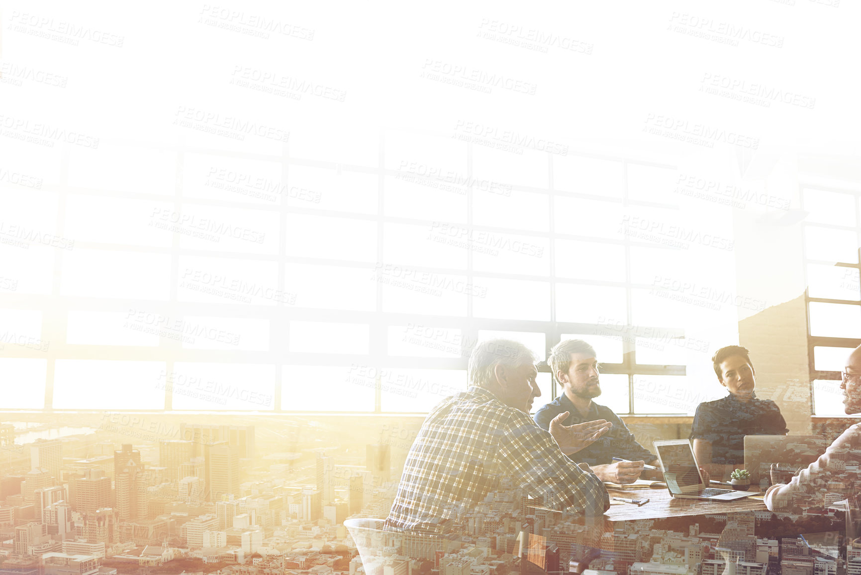 Buy stock photo Multiple exposure shot of businesspeople having a meeting superimposed over a cityscape