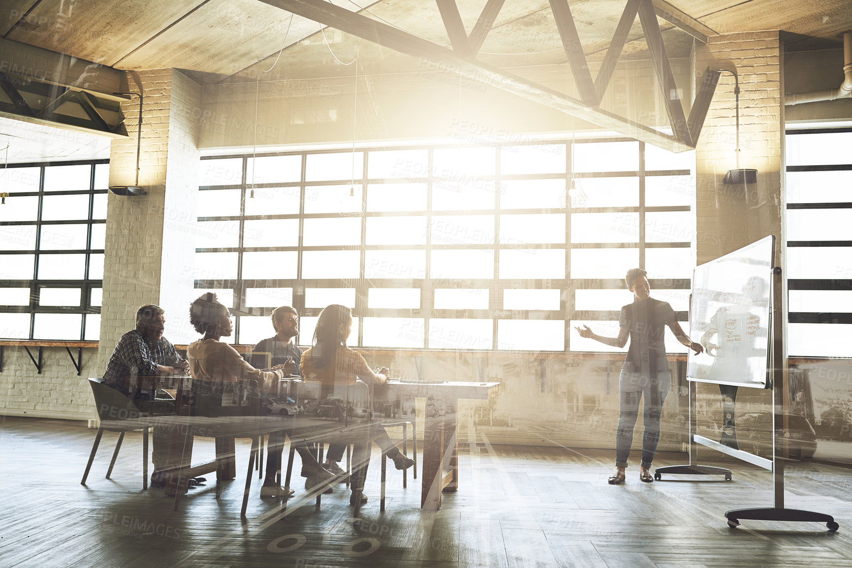 Buy stock photo Multiple exposure shot of businesspeople having a meeting superimposed over a cityscape