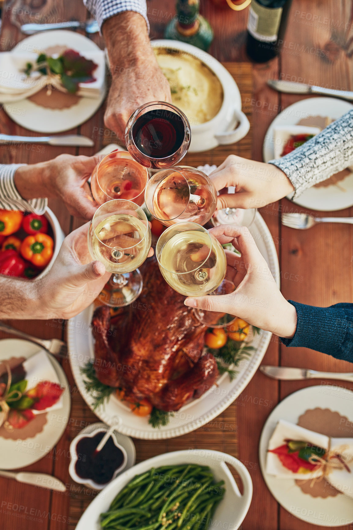 Buy stock photo Thanksgiving, toast and wine with hands of people at home dining room table for celebration from above. Dinner party, food and roast with friends in apartment together for cheers or social gathering