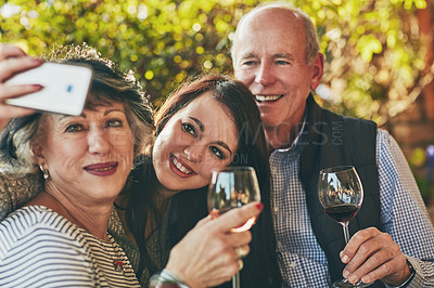 Buy stock photo Shot of a young woman taking a selfie with her parents