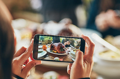 Buy stock photo Cropped shot of a woman taking a picture of a turkey on a dining table