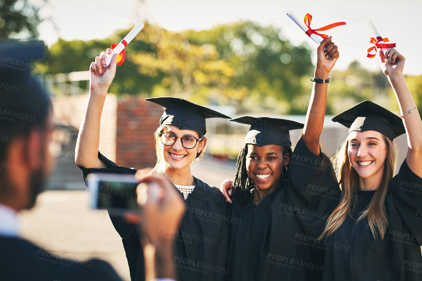 Buy stock photo Phone, students and outdoor graduation photography, diploma celebration and capture memory. People, friends and certified together for university success, social media post and women for victory