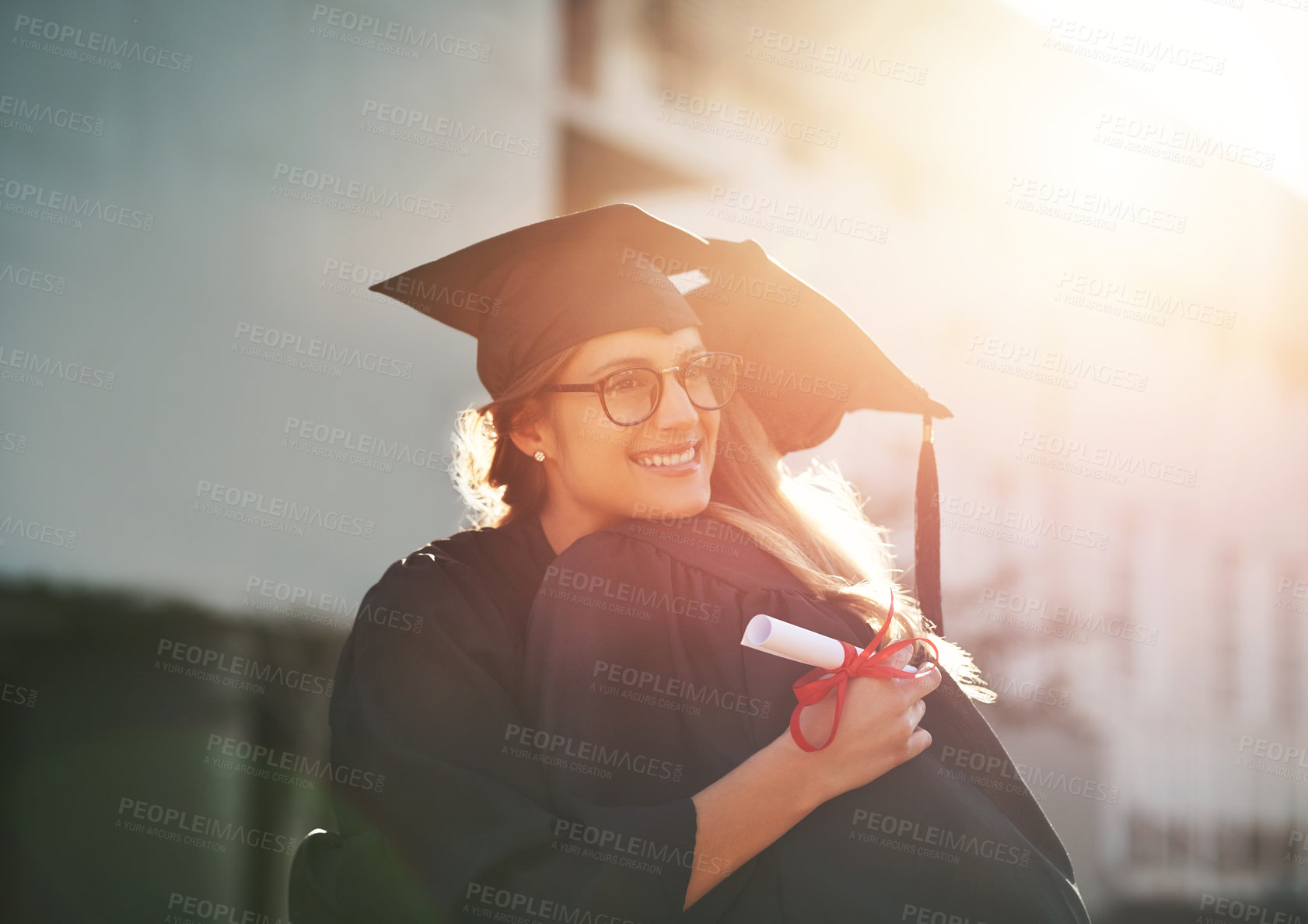 Buy stock photo Graduate, hug and happy for graduation, celebration and university outdoor with certificate success. Students, support and people for achievement, education and college with award and congratulations