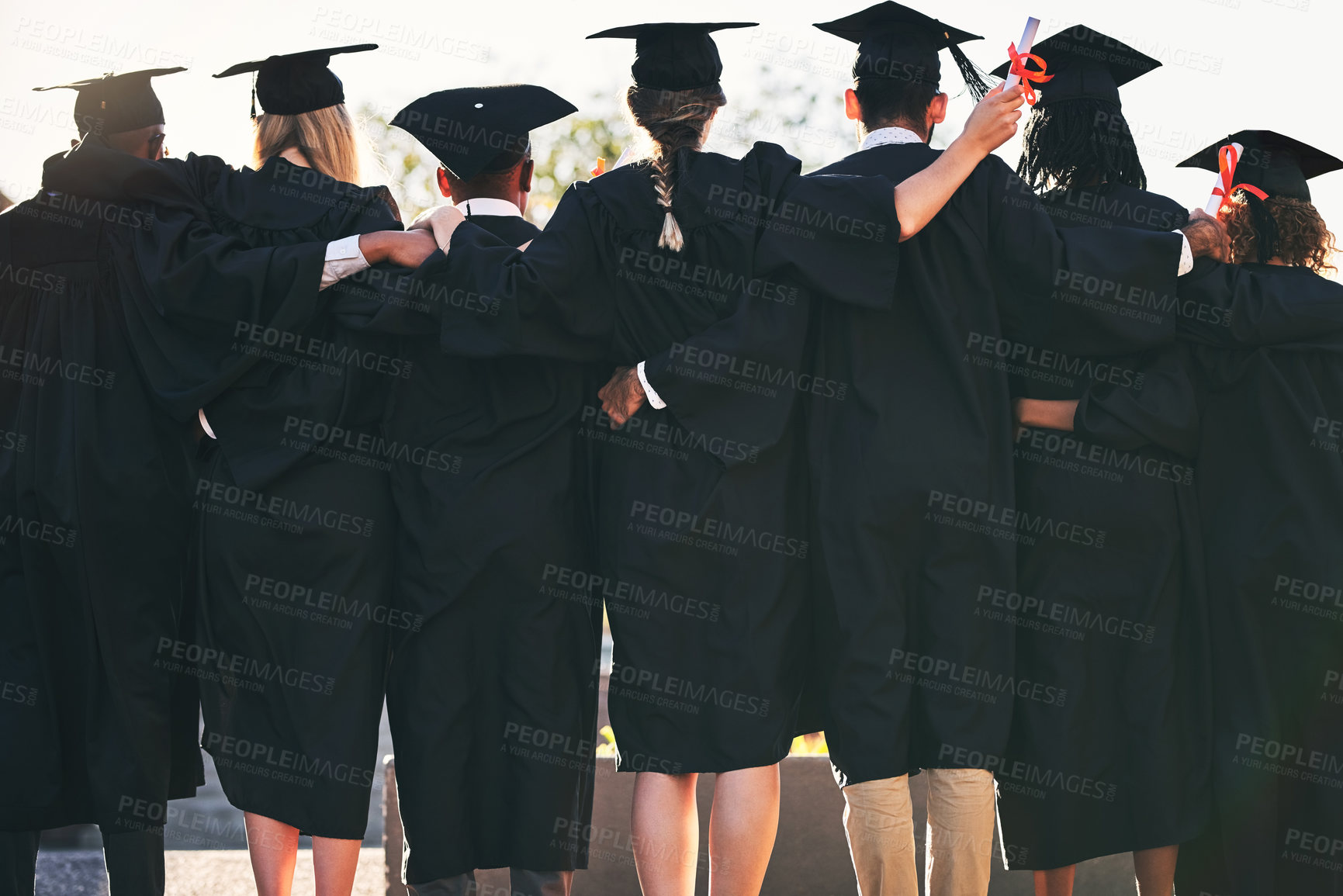 Buy stock photo Graduation, hug and back of students with friends at university for education, opportunity or success. School, scholarship and group of people at campus with college degree, bright future or diploma