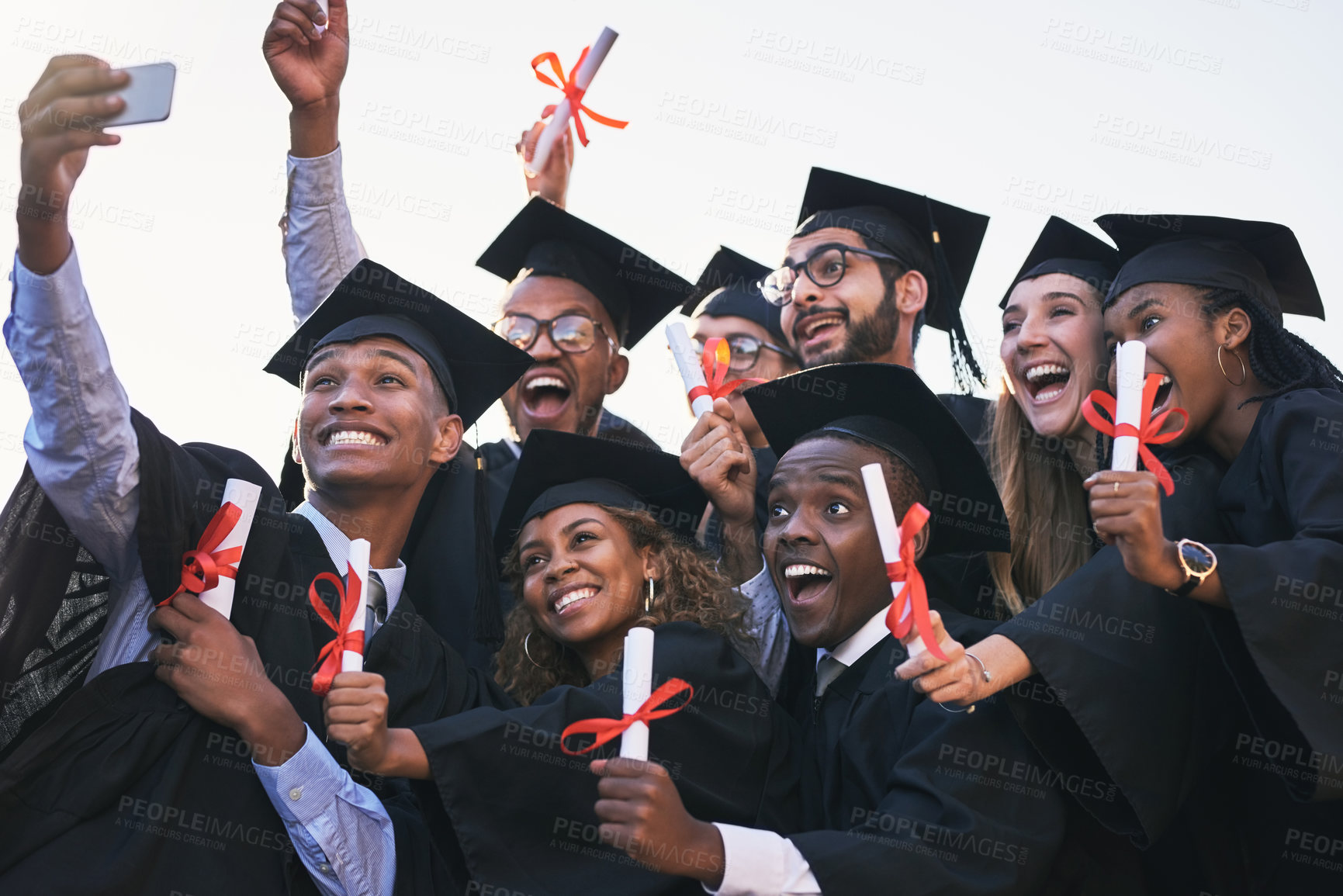 Buy stock photo Celebration, graduation and selfie with student friends outdoor on campus together for ceremony or event. Diversity, education and success with photograph of happy graduate people cheering for future