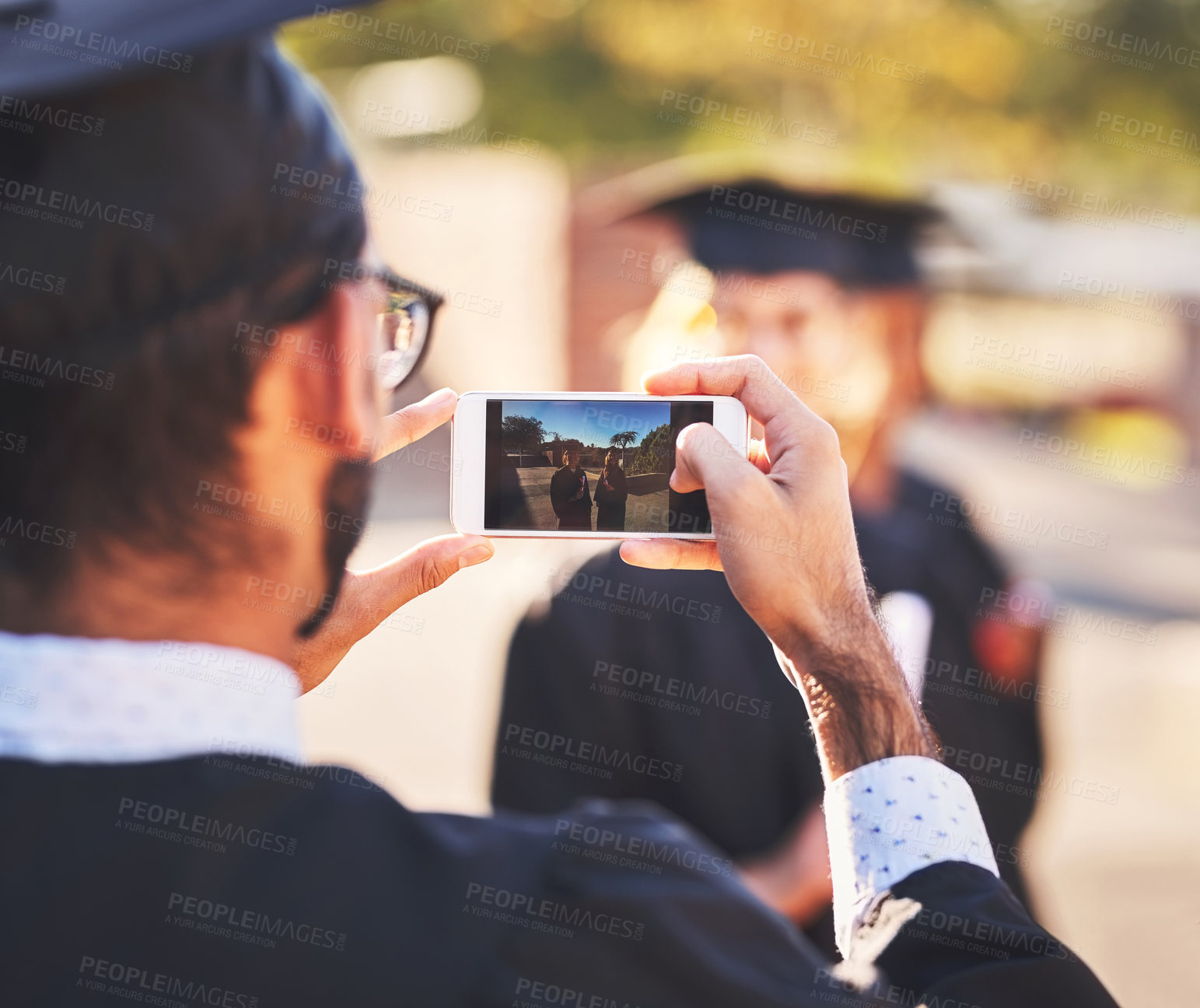 Buy stock photo Phone, screen and students for graduation photography in outdoor, diploma celebration and memory. People, friends and certified together for university success, social media post and support goals