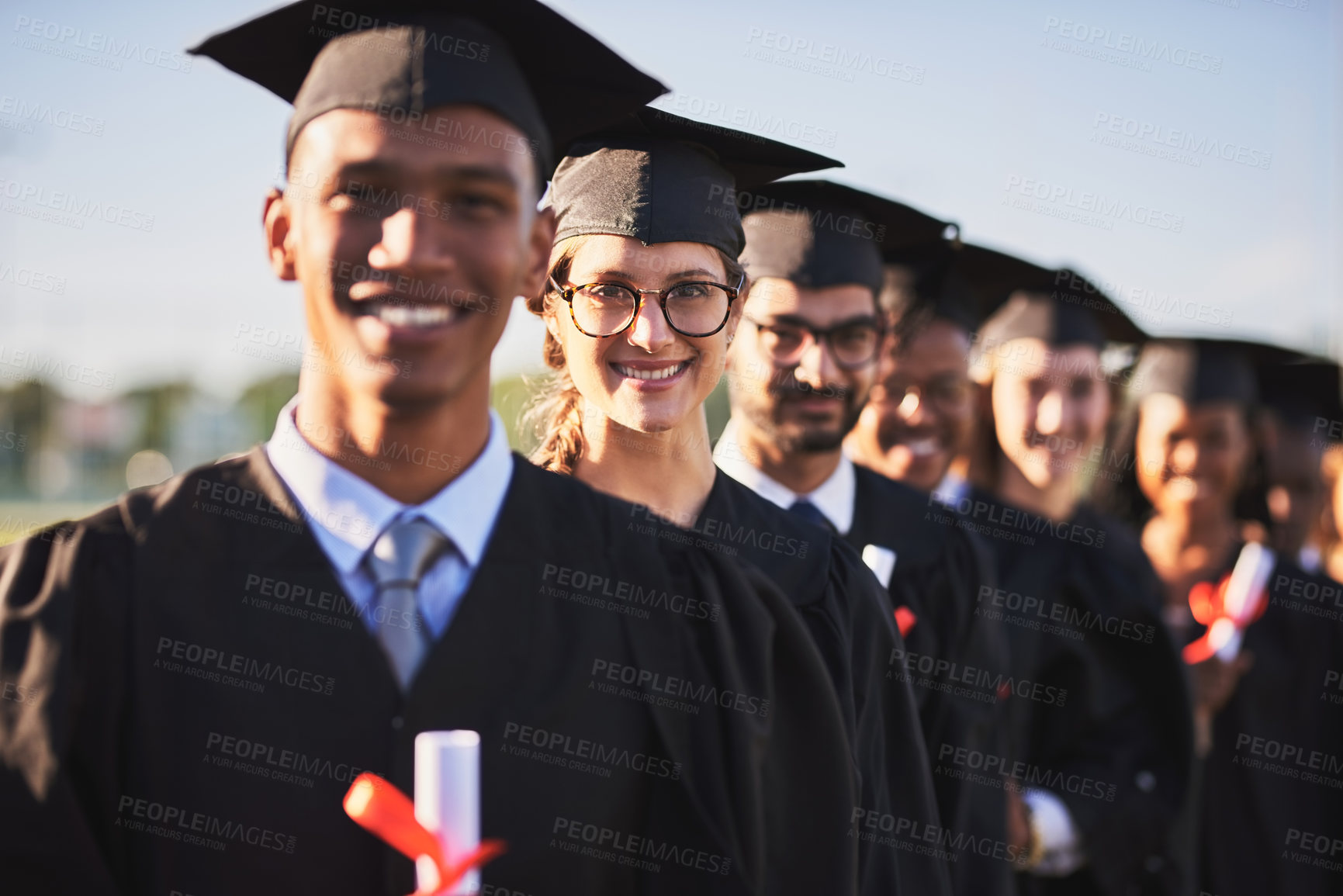 Buy stock photo Celebration, graduation and portrait of student woman outdoor on campus with friends for ceremony or event. Certificate, education and success with happy graduate people in line for award or future