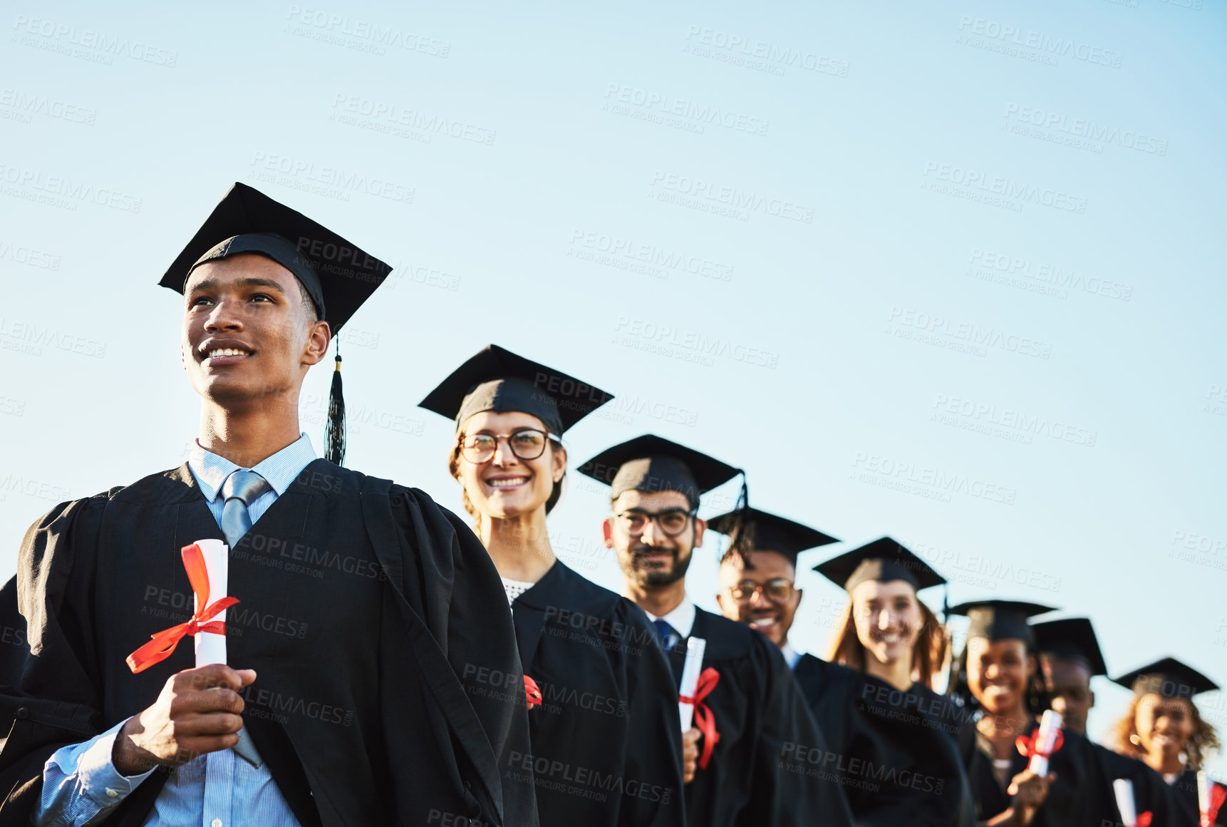 Buy stock photo Celebration, future and graduation with student friends outdoor on campus together for ceremony or event. Diversity, education and vision with group of happy graduate in line at college or university