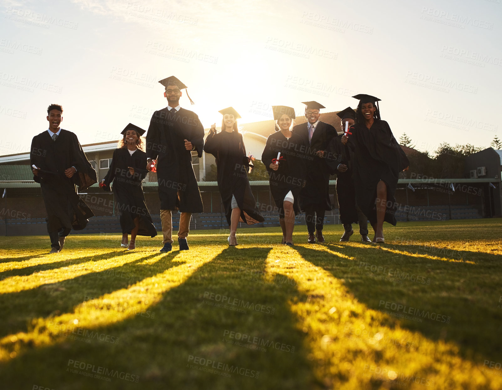 Buy stock photo Graduation, group portrait and campus lawn with college success, student celebration and diploma event at university. Friends, outdoor and academy achievement with ceremony, people and happy together