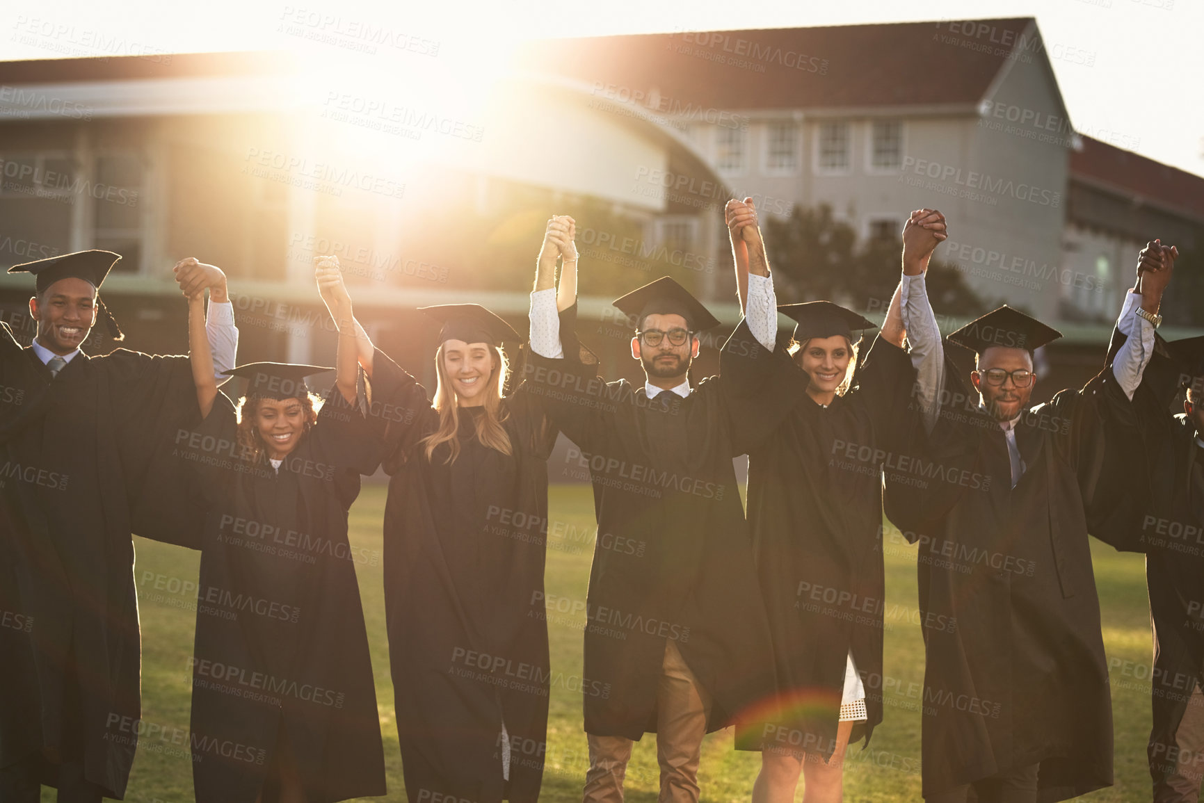 Buy stock photo Graduation, group and portrait with holding hands on campus lawn with college success, celebration and event. Friends, outdoor and academy achievement with student, people and university support