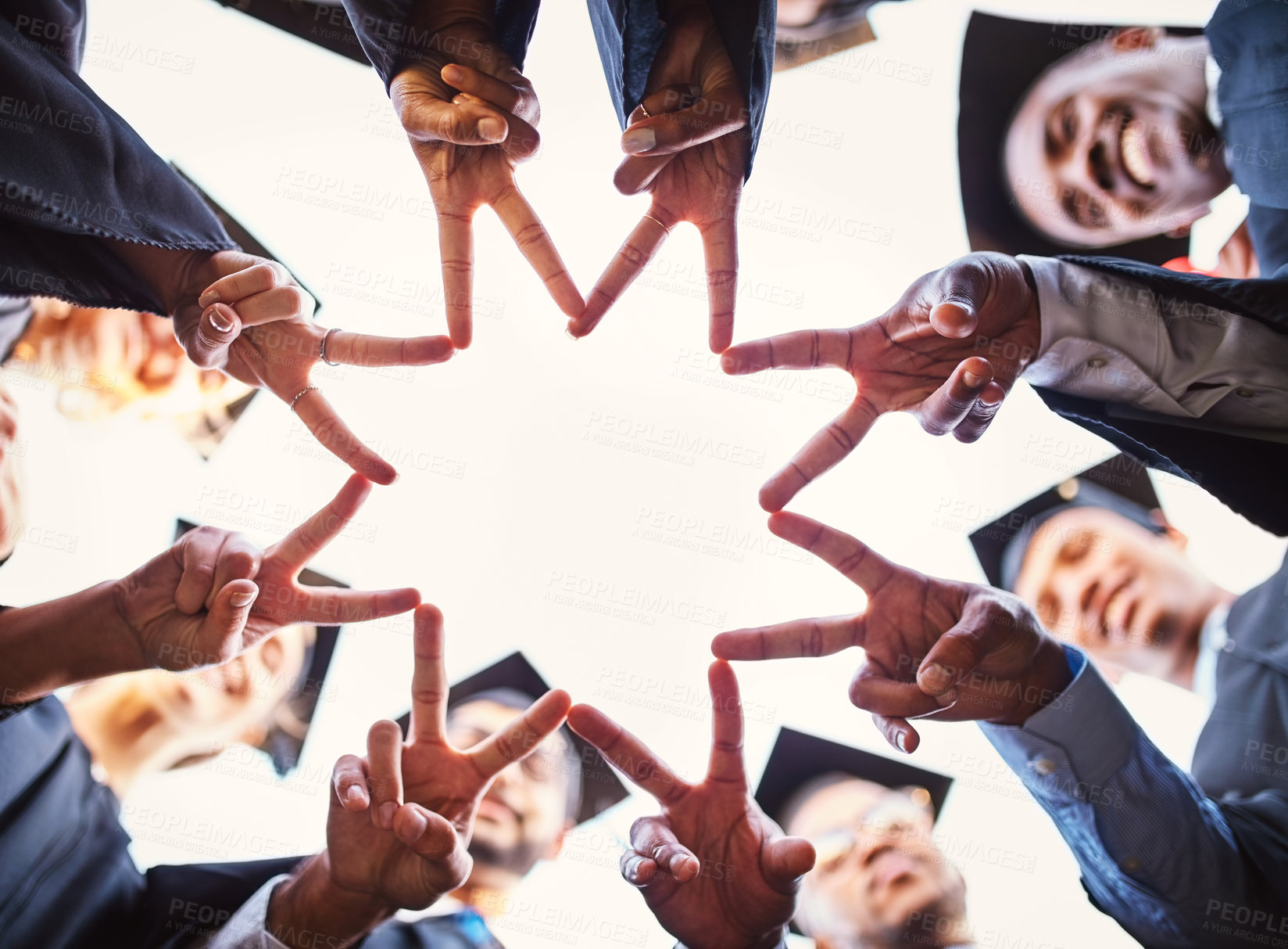 Buy stock photo Graduation, university students and hands with peace sign in circle for celebration, achievement and victory. People, low angle and college and classmates with smile or happy for qualification