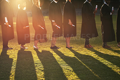 Buy stock photo Cropped shot of a group of university students standing together on graduation day