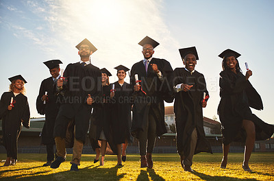 Buy stock photo Graduation, group portrait and run on campus lawn with college success, student celebration and diploma event at university. Friends, outdoor and academy achievement with happy people and freedom