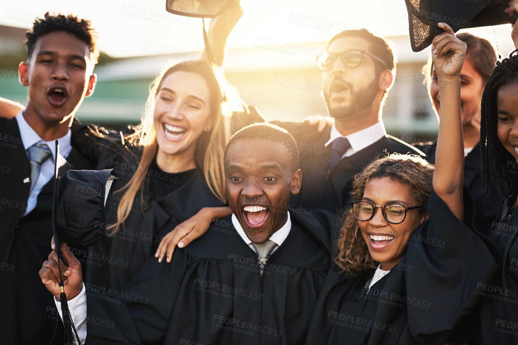 Buy stock photo Group, people and diversity at college graduation, happiness for degree or diploma certificate. Team, graduates and celebrating for academic achievement at university campus, excited for knowledge