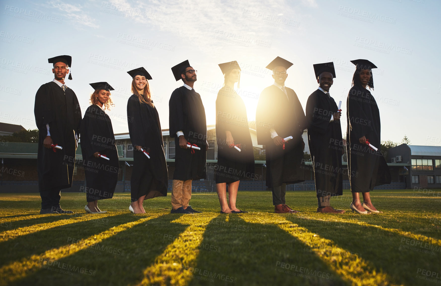 Buy stock photo Row, group and graduation of students, proud and together with degree, achievement and happy in school. University, certificate and qualification in academy, celebration and portrait of people