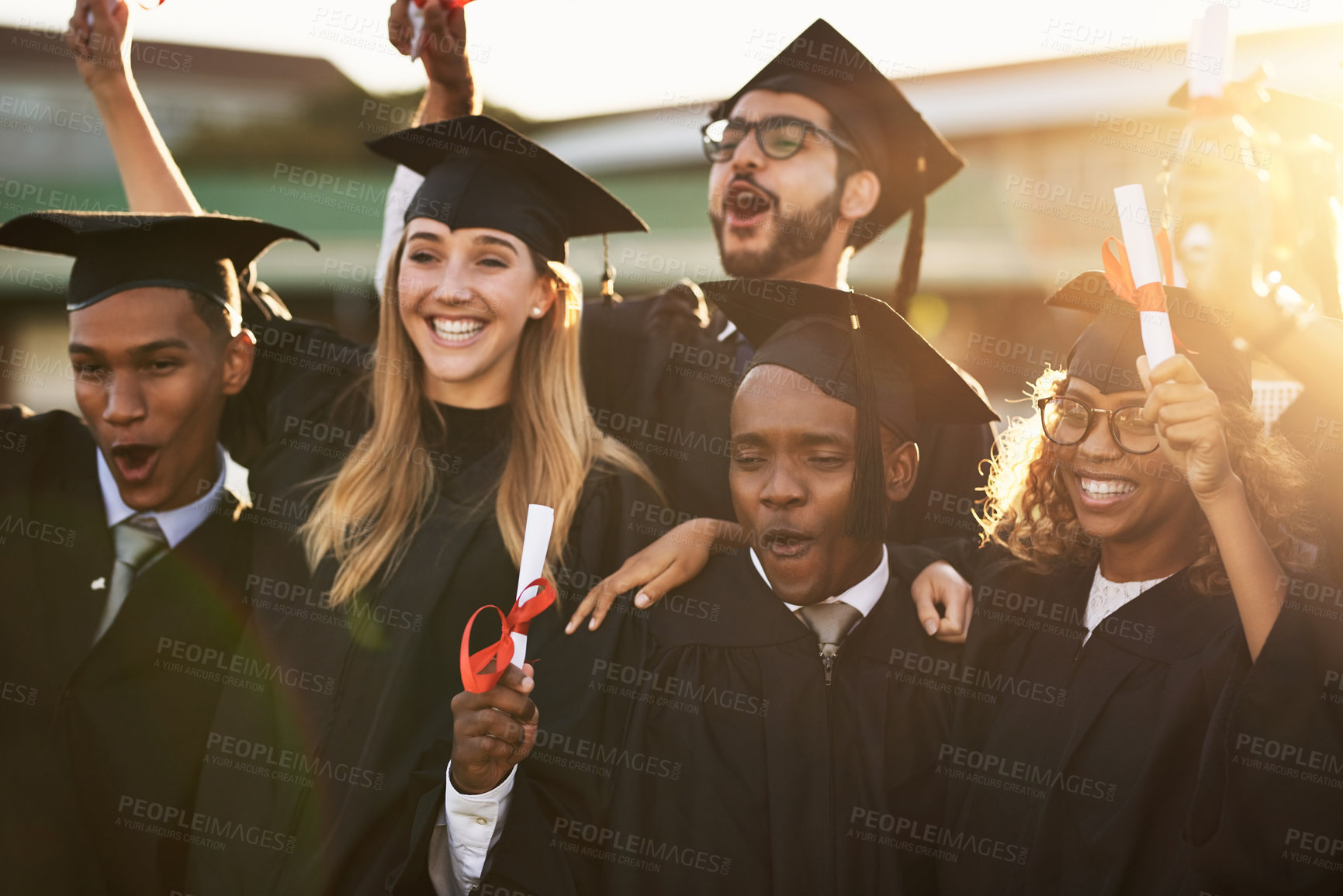 Buy stock photo Shot of a group of cheerful university students on graduation day