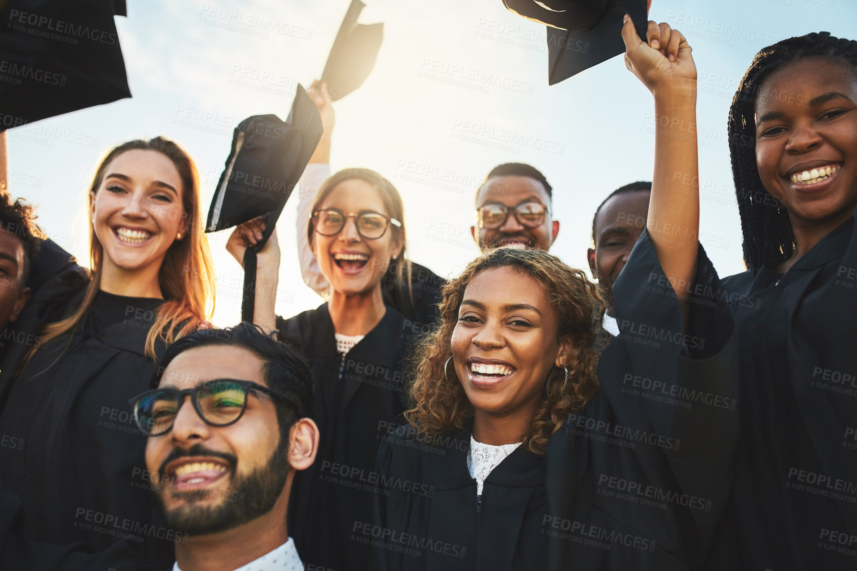 Buy stock photo Group, graduates and diversity at university graduation, happiness for degree or diploma certificate. Team, students and celebrating for academic achievement at college campus, smile for knowledge