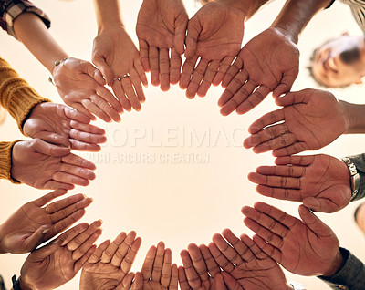 Buy stock photo Low angle shot of a group of people joining their hands together