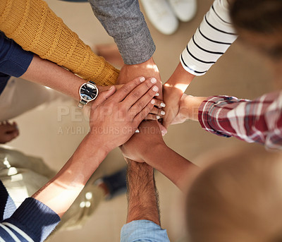 Buy stock photo High angle shot of a group of people joining their hands together