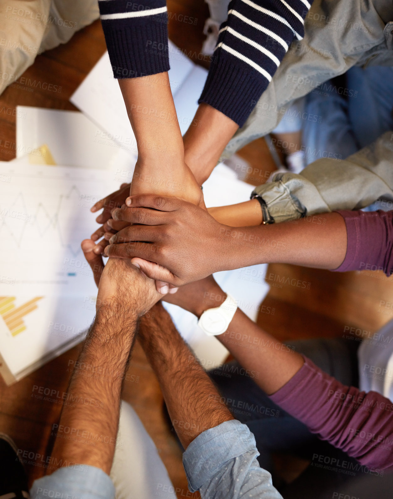 Buy stock photo High angle shot of a group of people joining their hands together