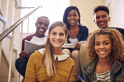 Buy stock photo Cropped portrait of a group of young university students sitting on their campus staircase