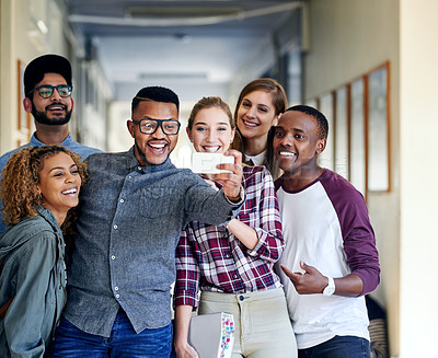 Buy stock photo Cropped shot of a group of young university students taking selfies on campus