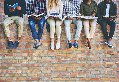 Buy stock photo University student, group and books on wall with legs, learning and progress for development at campus. People, friends and scholarship for education, information and knowledge for future at college