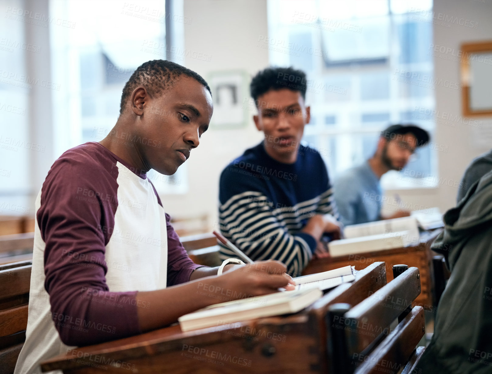 Buy stock photo Cropped shot of university students sitting in class