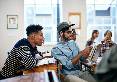 Buy stock photo Cropped shot of university students going through notes together in class