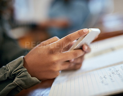 Buy stock photo Closeup shot of an unrecognizable university student using a cellphone in class