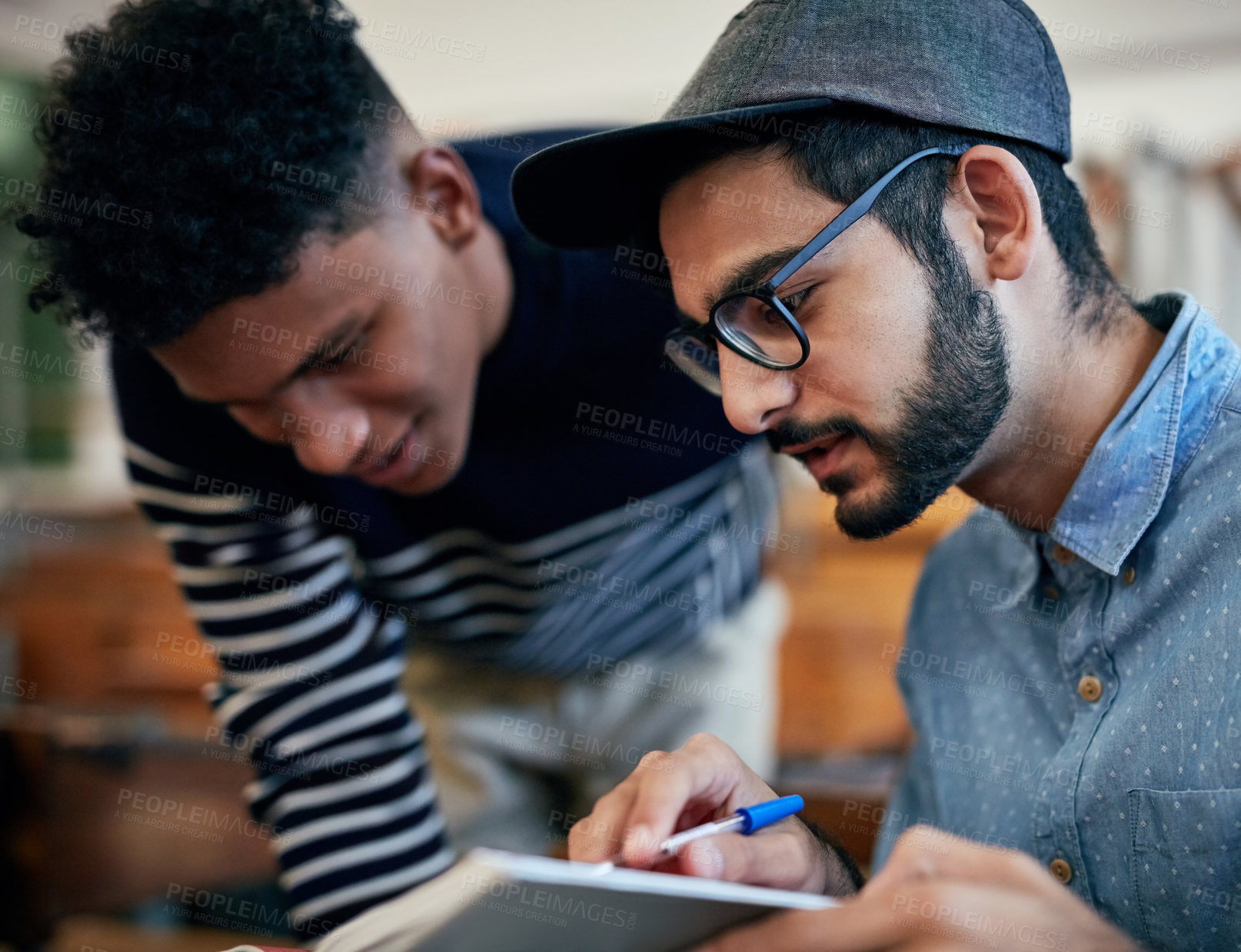 Buy stock photo Cropped shot of university students studying together in class