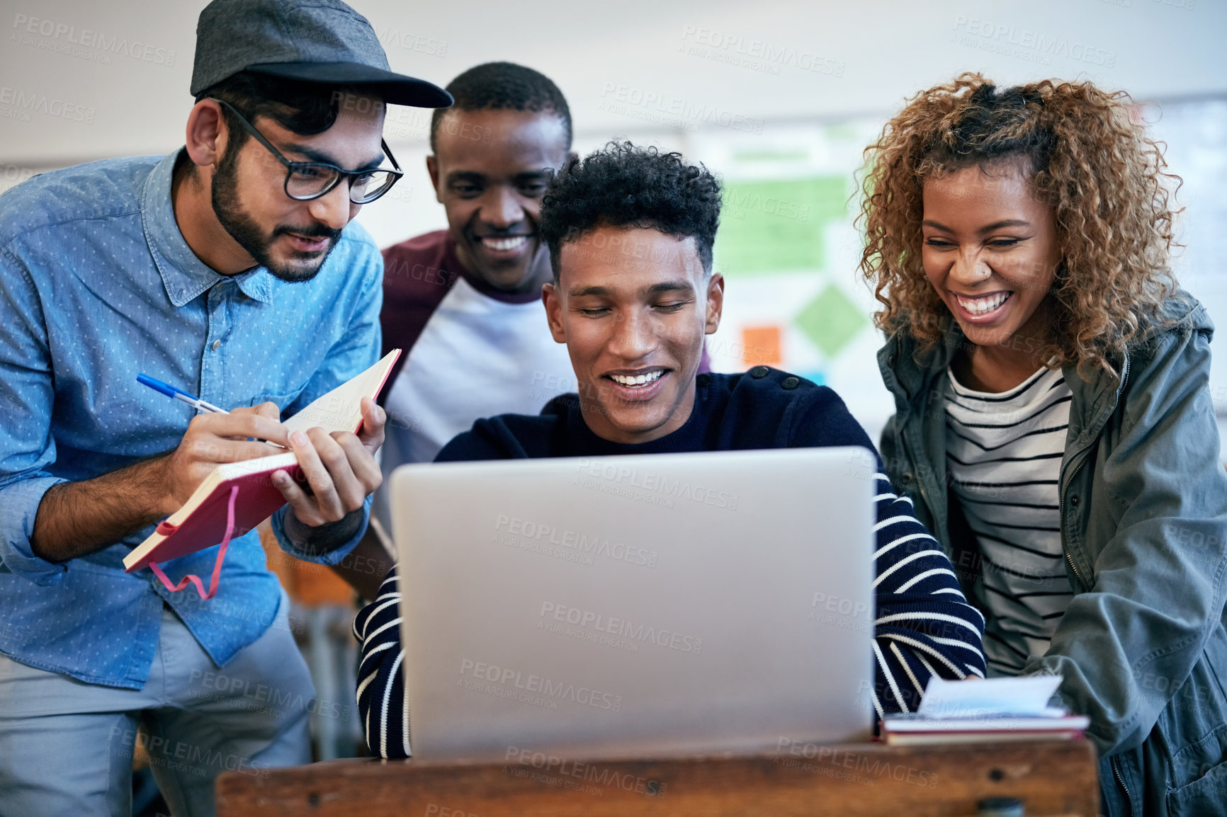 Buy stock photo Cropped shot of university students using a laptop together in class