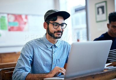 Buy stock photo Man, classroom and university with laptop for research, reading message on application at school. Male student, college or social media with education or learning, scroll for news story with glasses