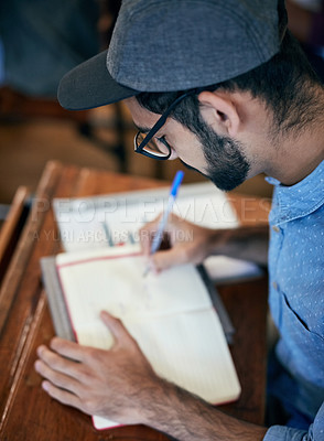 Buy stock photo Cropped shot of an university student writing notes in class