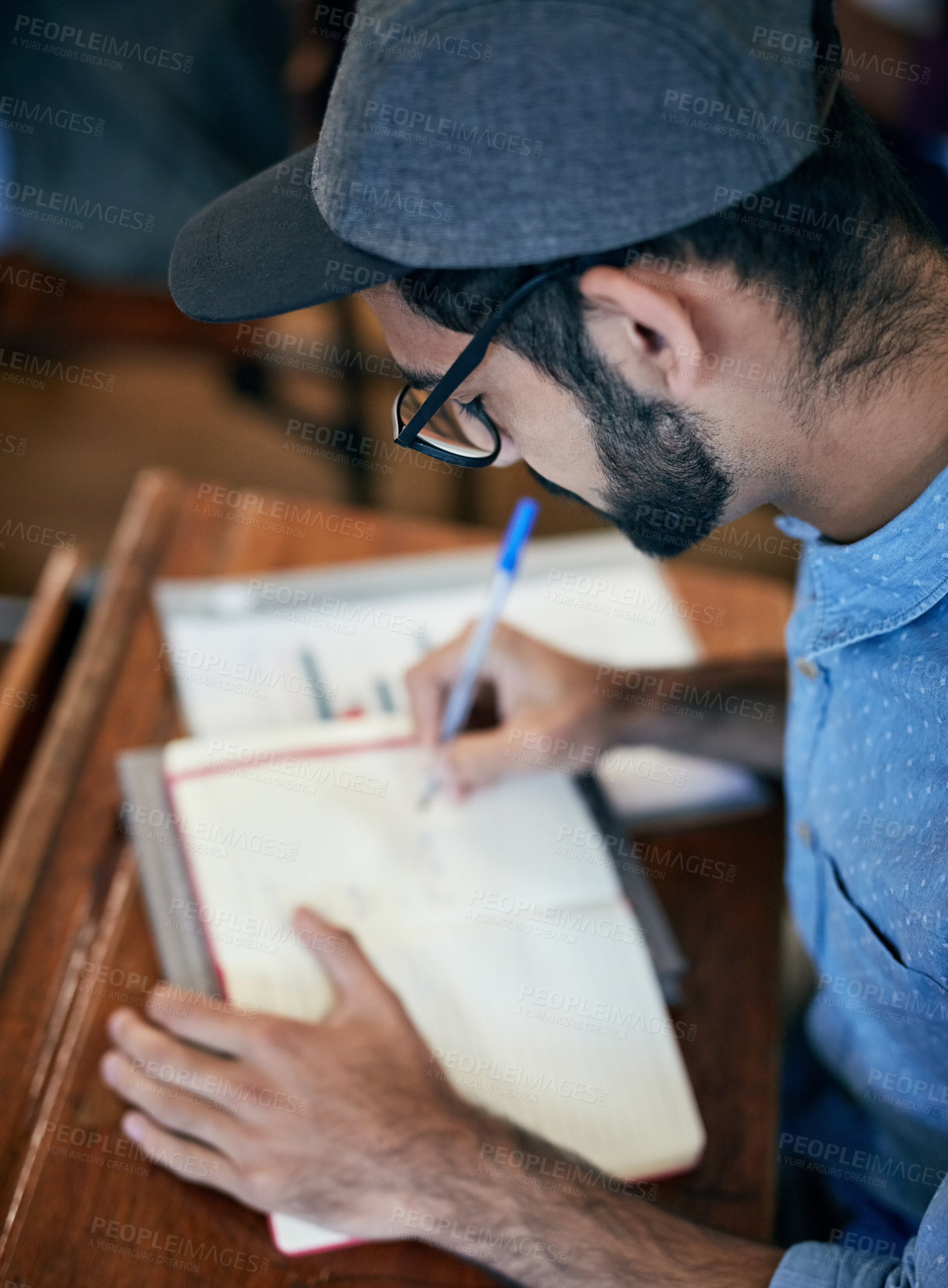 Buy stock photo Cropped shot of an university student writing notes in class