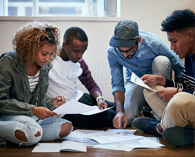 Buy stock photo Cropped shot of university students working together on the floor in class