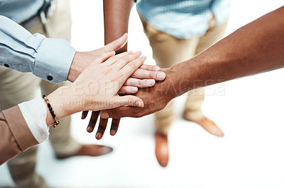 Buy stock photo Cropped shot of colleagues joining their hands together in unity