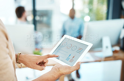 Buy stock photo Cropped shot of a businesswoman using her digital tablet in the office
