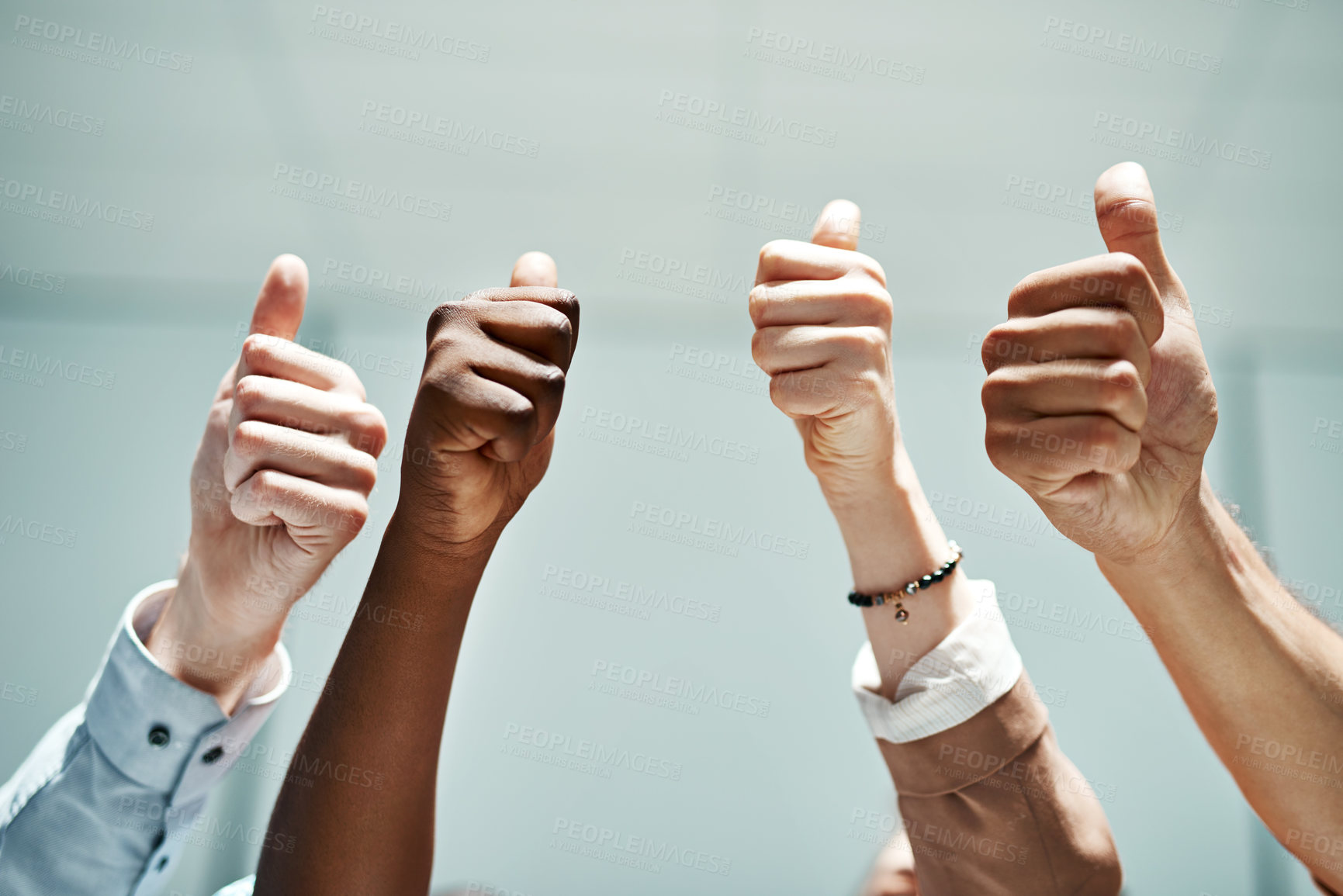 Buy stock photo Cropped shot of colleagues showing thumbs up