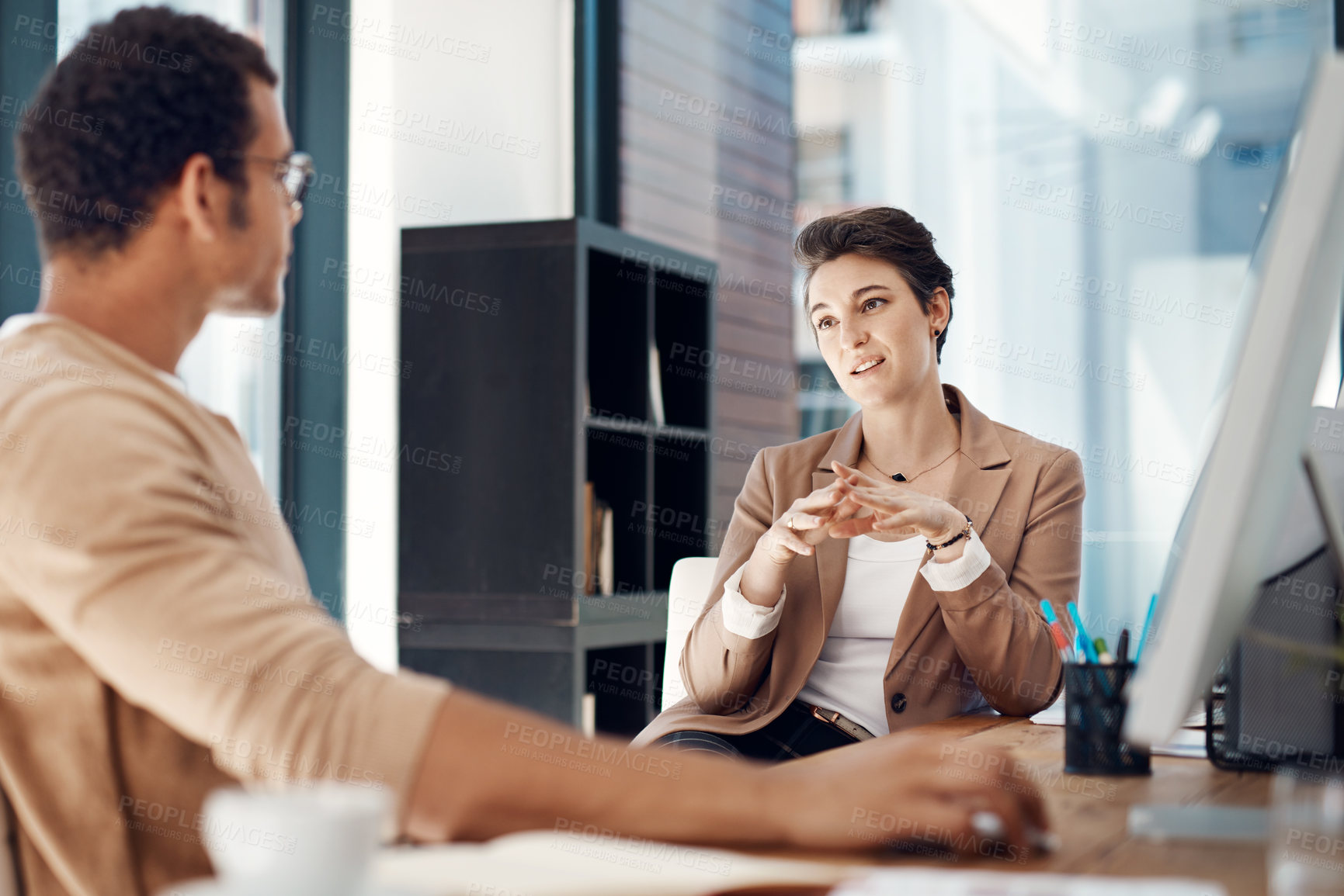 Buy stock photo Shot of two businesspeople having a discussion in an office