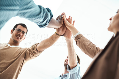 Buy stock photo Shot of a group of businesspeople high fiving each other in an office