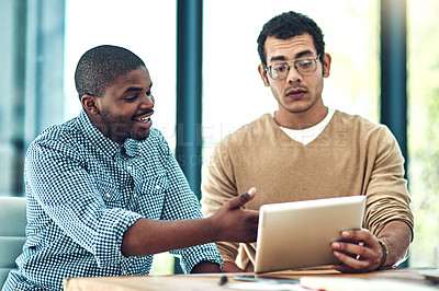 Buy stock photo Cropped shot of two young designers discussing something on a digital tablet