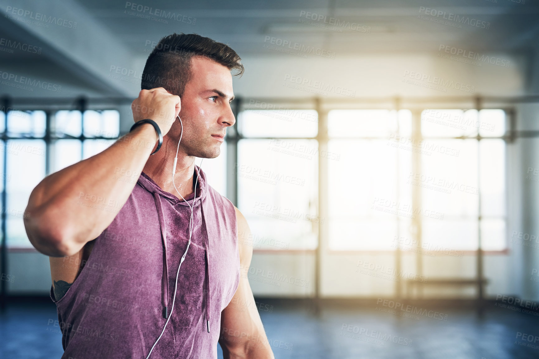 Buy stock photo Muscular, training and man in gym, listening to music and exercise with podcast for motivation. Healthy person, thinking and bodybuilder with sound, audio or wellness with workout, challenge or radio