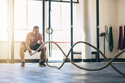 Buy stock photo Battle rope, man and fitness in gym, challenge and cardio workout with exercise, training routine and wellness. Person, bodybuilder or guy in health facility, energy and sports with athlete or strong