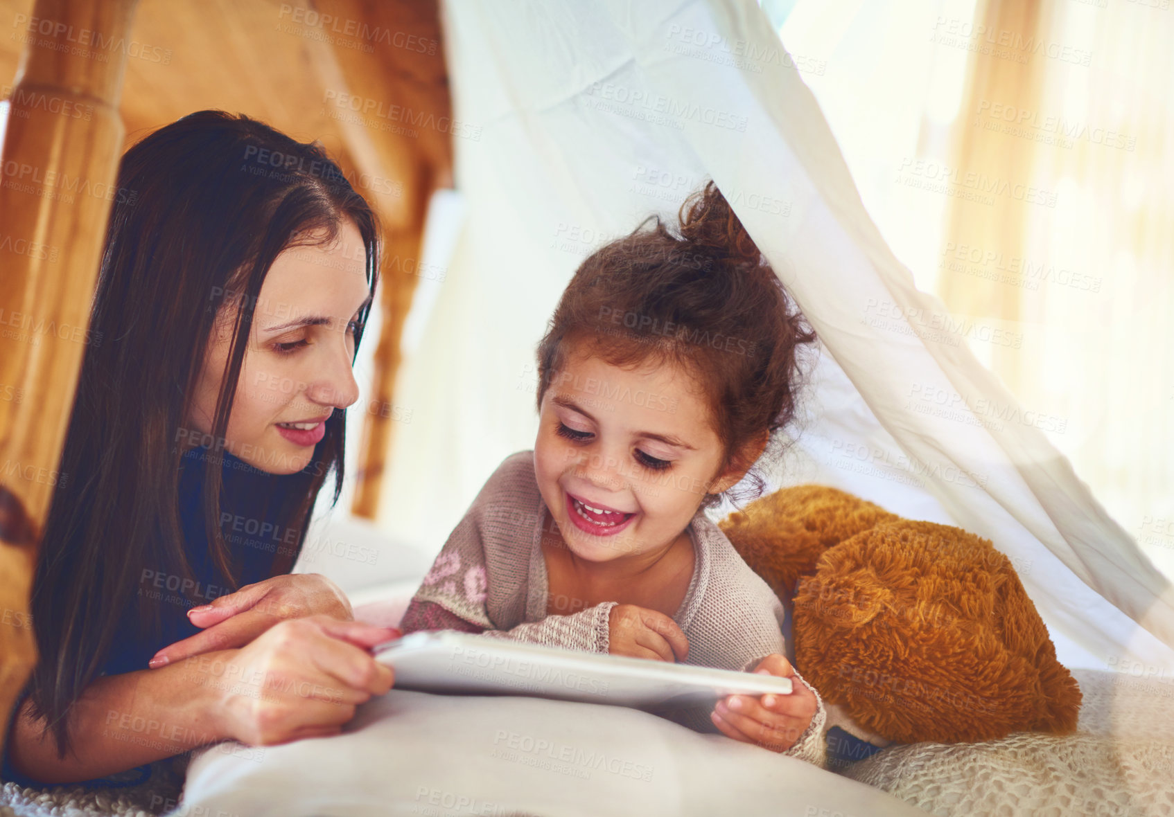 Buy stock photo Home, mother and girl with tablet, family and social media with happiness, bonding together and online game. Love, single parent and mama with daughter, tech and digital app for cartoon film in house