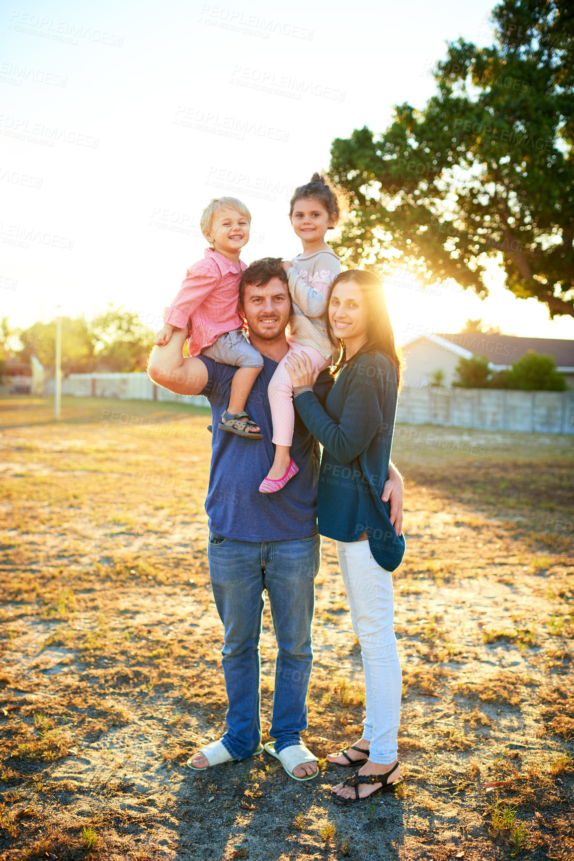 Buy stock photo Happy, portrait and parents with children on shoulders for bonding, playing and having fun together. Smile, family and young dad and mom carrying girl kids for connection outdoor in park in Canada.