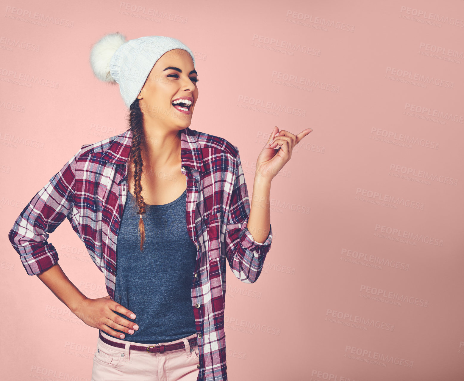 Buy stock photo Woman, laughing and pointing in studio for joke, funny news and choice with comedy by pink background. Female person, model and hand gesture by mockup space for advertising, marketing and branding